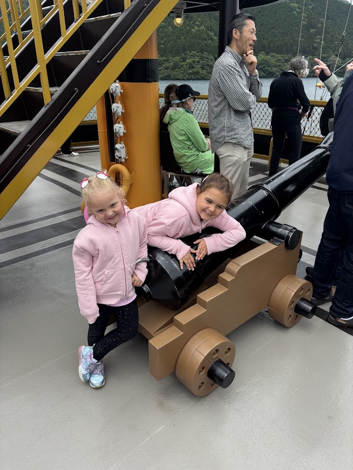Kids in front of pirate ship cannon