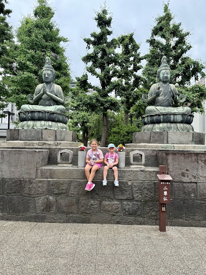 Kids in front of statues outside of Senso-Ji Temple